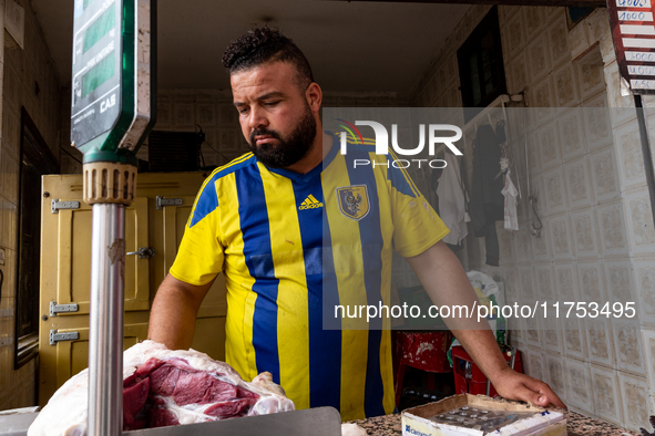 A man sells fresh meat on a small stand on a street in Tozeur, central Tunisia on October 27, 2024. Tunisia is well known for its natural an...