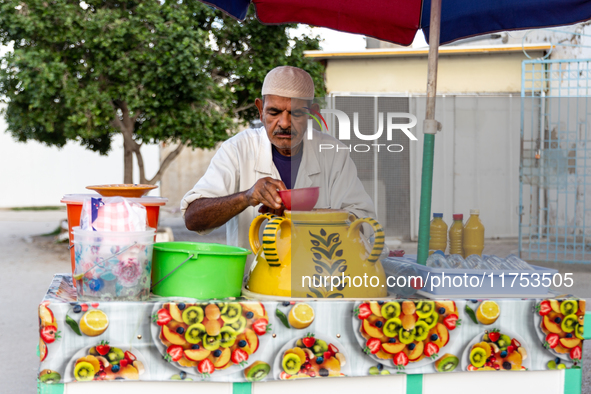 A man sells fresh curcuma drink on a small stand on a street in Kairouan, central Tunisia on October 31, 2024. Tunisia is well known for its...