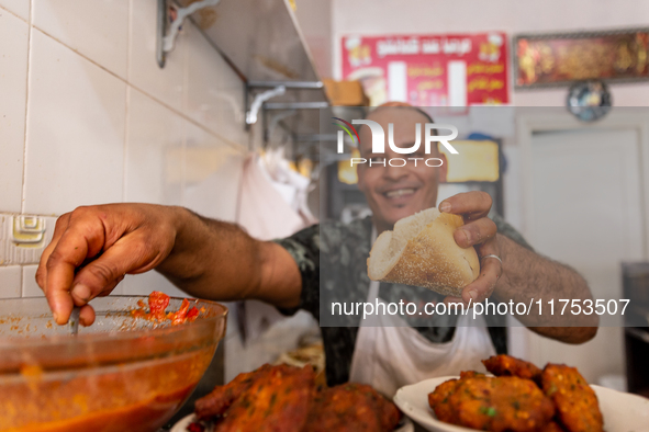 A man sells fresh sandwiches on a small stand on a street in Kairouan, central Tunisia on October 31, 2024. Tunisia is well known for its na...