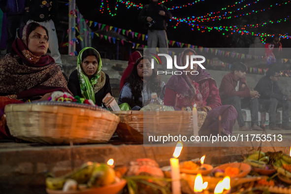 A Hindu devotee lights traditional oil lamps as she offers prayers to the sun during the Chhath Puja festival on the banks of the Bagmati Ri...