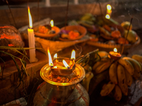 A Hindu devotee lights traditional oil lamps as she offers prayers to the sun during the Chhath Puja festival on the banks of the Bagmati Ri...