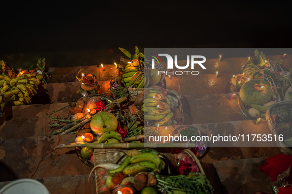 A Hindu devotee lights traditional oil lamps as she offers prayers to the sun during the Chhath Puja festival on the banks of the Bagmati Ri...