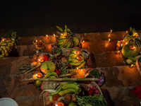 A Hindu devotee lights traditional oil lamps as she offers prayers to the sun during the Chhath Puja festival on the banks of the Bagmati Ri...