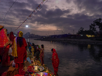 A Hindu devotee lights traditional oil lamps as she offers prayers to the sun during the Chhath Puja festival on the banks of the Bagmati Ri...