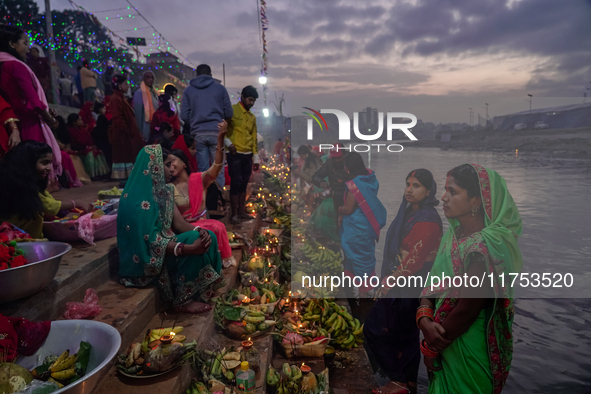 A Hindu devotee lights traditional oil lamps as she offers prayers to the sun during the Chhath Puja festival on the banks of the Bagmati Ri...