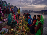 A Hindu devotee lights traditional oil lamps as she offers prayers to the sun during the Chhath Puja festival on the banks of the Bagmati Ri...