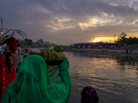 Hindu devotees perform rituals and offer prayers to the rising Sun God on the banks of the Bagmati River during the 'Chhath Puja' festival i...