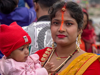 Hindu devotees perform rituals and offer prayers to the rising Sun God on the banks of the Bagmati River during the 'Chhath Puja' festival i...