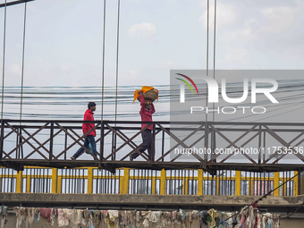 Hindu devotees return after the rituals and offer prayers to the rising Sun God on the banks of the Bagmati River during the 'Chhath Puja' f...