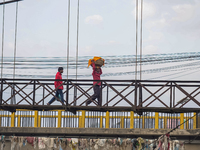 Hindu devotees return after the rituals and offer prayers to the rising Sun God on the banks of the Bagmati River during the 'Chhath Puja' f...