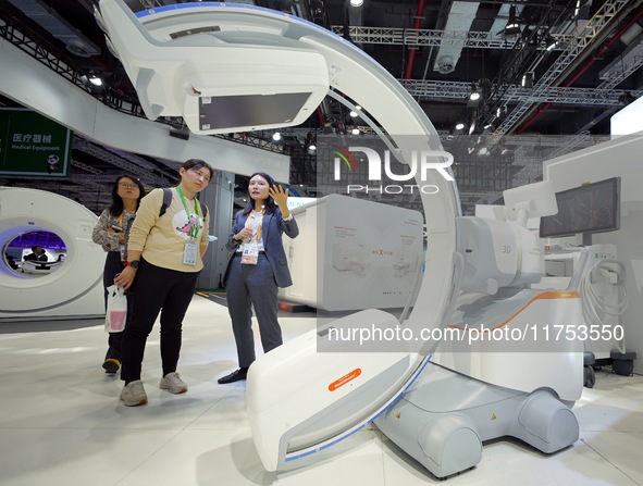 Visitors learn about the world's first ''driverless'' C-arm CIARTIC Move, which debuts in Asia, at the Siemens Medical booth at the 7th CIIE...