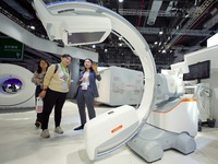 Visitors learn about the world's first ''driverless'' C-arm CIARTIC Move, which debuts in Asia, at the Siemens Medical booth at the 7th CIIE...