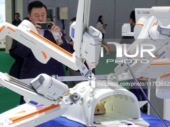 Visitors experience the Medtronic Hugo RAS robot-assisted surgery system at the 7th CIIE in Shanghai, China, on November 8, 2024. (