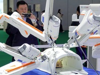 Visitors experience the Medtronic Hugo RAS robot-assisted surgery system at the 7th CIIE in Shanghai, China, on November 8, 2024. (