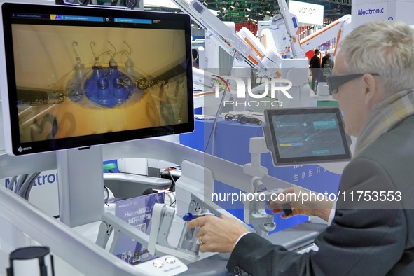 Visitors experience the Medtronic Hugo RAS robot-assisted surgery system at the 7th CIIE in Shanghai, China, on November 8, 2024. 