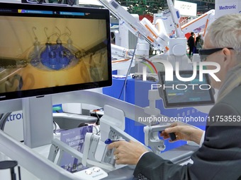 Visitors experience the Medtronic Hugo RAS robot-assisted surgery system at the 7th CIIE in Shanghai, China, on November 8, 2024. (