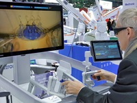 Visitors experience the Medtronic Hugo RAS robot-assisted surgery system at the 7th CIIE in Shanghai, China, on November 8, 2024. (