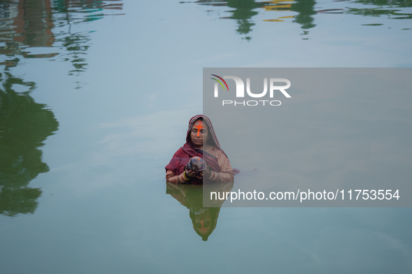 Devotees worship the rising sun in Kamalpokhari, Bhaktapur, on the last day of the Chhath Festival. Chhath is a Hindu festival dedicated to...