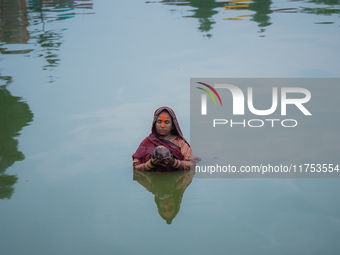 Devotees worship the rising sun in Kamalpokhari, Bhaktapur, on the last day of the Chhath Festival. Chhath is a Hindu festival dedicated to...