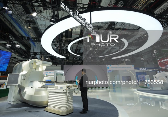 A staff member demonstrates the TrueBeam stereotactic radiotherapy platform at the Varian Medical booth at the 7th CIIE in Shanghai, China,...