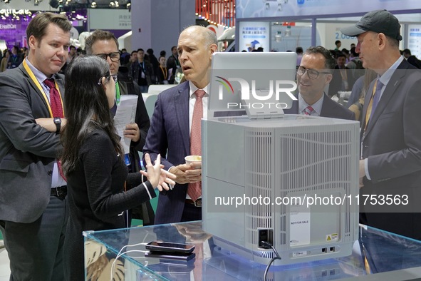 The audience learns about the desktop gene sequencer at the Meina booth at the 7th CIIE in Shanghai, China, on November 8, 2024. 