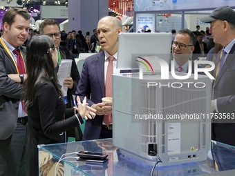 The audience learns about the desktop gene sequencer at the Meina booth at the 7th CIIE in Shanghai, China, on November 8, 2024. (