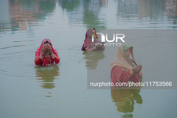 Devotees worship the rising sun in Kamalpokhari, Bhaktapur, on the last day of the Chhath Festival. Chhath is a Hindu festival dedicated to...