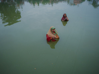 Devotees worship the rising sun in Kamalpokhari, Bhaktapur, on the last day of the Chhath Festival. Chhath is a Hindu festival dedicated to...