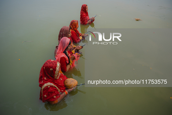 Devotees worship the rising sun in Kamalpokhari, Bhaktapur, on the last day of the Chhath Festival. Chhath is a Hindu festival dedicated to...