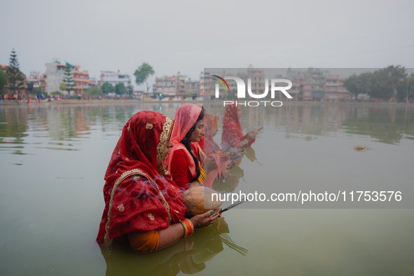 Devotees worship the rising sun in Kamalpokhari, Bhaktapur, on the last day of the Chhath Festival. Chhath is a Hindu festival dedicated to...