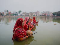 Devotees worship the rising sun in Kamalpokhari, Bhaktapur, on the last day of the Chhath Festival. Chhath is a Hindu festival dedicated to...