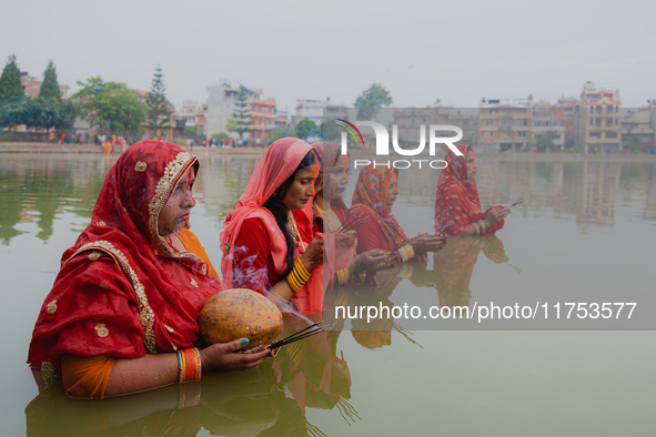 Devotees worship the rising sun in Kamalpokhari, Bhaktapur, on the last day of the Chhath Festival. Chhath is a Hindu festival dedicated to...