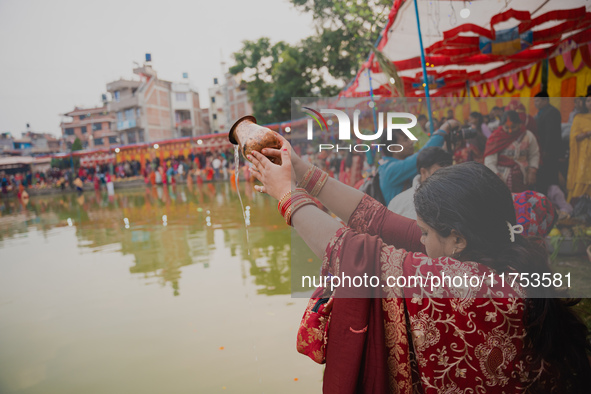 Devotees worship the rising sun in Kamalpokhari, Bhaktapur, on the last day of the Chhath Festival. Chhath is a Hindu festival dedicated to...