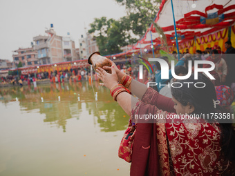 Devotees worship the rising sun in Kamalpokhari, Bhaktapur, on the last day of the Chhath Festival. Chhath is a Hindu festival dedicated to...