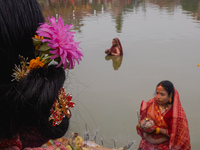 Devotees worship the rising sun in Kamalpokhari, Bhaktapur, on the last day of the Chhath Festival. Chhath is a Hindu festival dedicated to...