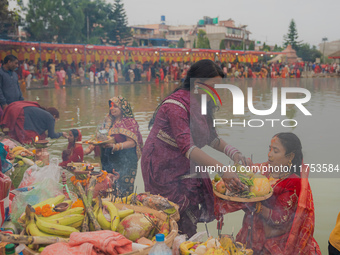 Devotees worship the rising sun in Kamalpokhari, Bhaktapur, on the last day of the Chhath Festival. Chhath is a Hindu festival dedicated to...