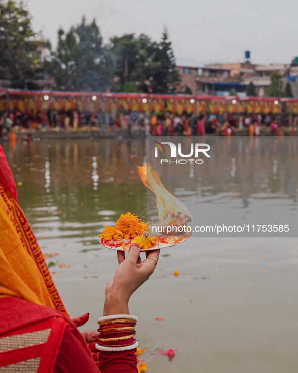 Devotees worship the rising sun in Kamalpokhari, Bhaktapur, on the last day of the Chhath Festival. Chhath is a Hindu festival dedicated to...