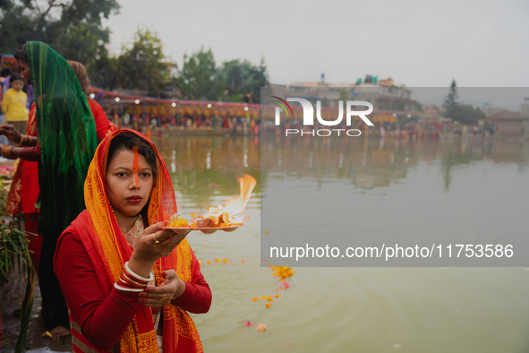 Devotees worship the rising sun in Kamalpokhari, Bhaktapur, on the last day of the Chhath Festival. Chhath is a Hindu festival dedicated to...