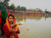 Devotees worship the rising sun in Kamalpokhari, Bhaktapur, on the last day of the Chhath Festival. Chhath is a Hindu festival dedicated to...