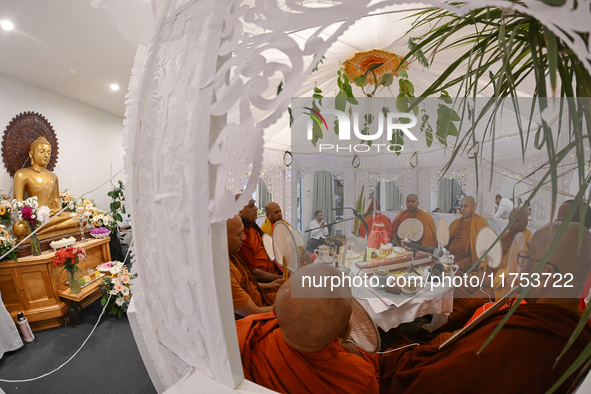 Buddhist monks chant during a pirith ceremony to invoke blessings ahead of the annual Kathina festival at Samadhi Buddhist Temple in Rollest...