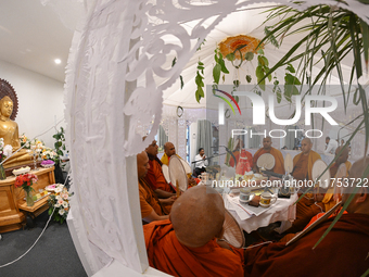 Buddhist monks chant during a pirith ceremony to invoke blessings ahead of the annual Kathina festival at Samadhi Buddhist Temple in Rollest...