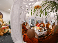 Buddhist monks chant during a pirith ceremony to invoke blessings ahead of the annual Kathina festival at Samadhi Buddhist Temple in Rollest...