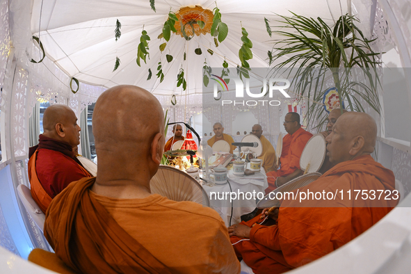 Buddhist monks chant during a pirith ceremony to invoke blessings ahead of the annual Kathina festival at Samadhi Buddhist Temple in Rollest...