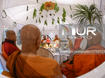 Buddhist monks chant during a pirith ceremony to invoke blessings ahead of the annual Kathina festival at Samadhi Buddhist Temple in Rollest...