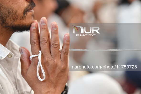 A devotee from the Sri Lankan Buddhist community offers prayers during a pirith chanting ceremony ahead of the annual Kathina festival at th...