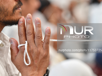 A devotee from the Sri Lankan Buddhist community offers prayers during a pirith chanting ceremony ahead of the annual Kathina festival at th...