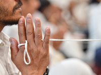 A devotee from the Sri Lankan Buddhist community offers prayers during a pirith chanting ceremony ahead of the annual Kathina festival at th...