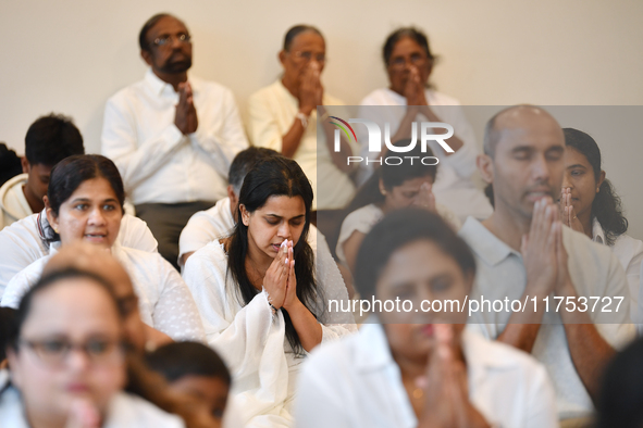 Devotees from the Sri Lankan Buddhist community offer prayers during a pirith chanting ceremony ahead of the annual Kathina festival at the...