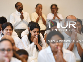 Devotees from the Sri Lankan Buddhist community offer prayers during a pirith chanting ceremony ahead of the annual Kathina festival at the...