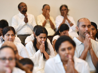 Devotees from the Sri Lankan Buddhist community offer prayers during a pirith chanting ceremony ahead of the annual Kathina festival at the...